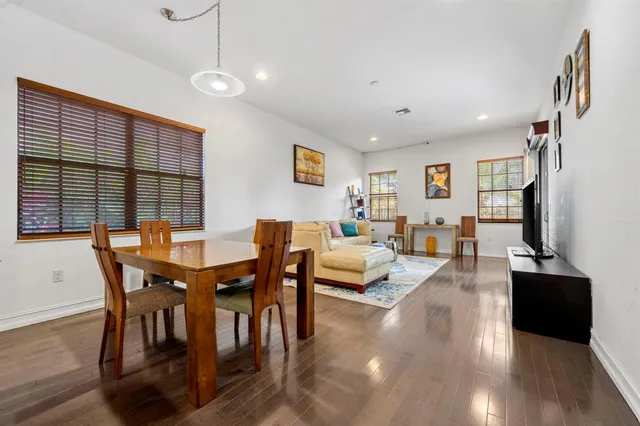 a view of a dining room with furniture and wooden floor