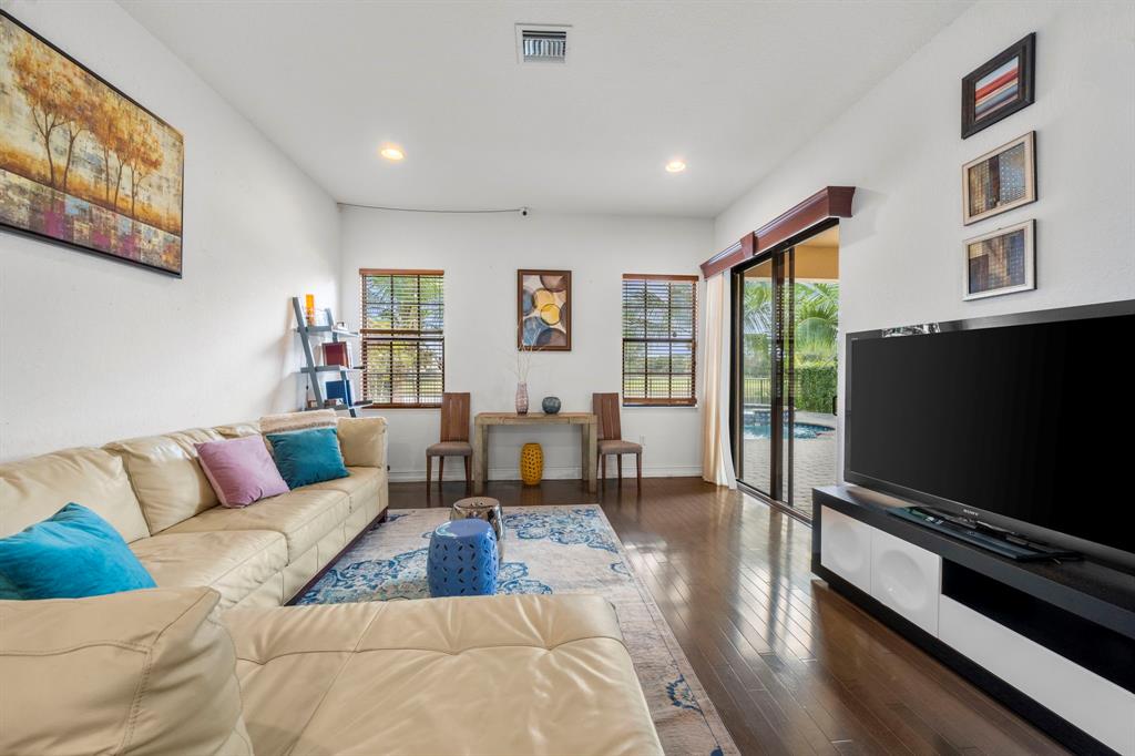7302 Northwest 111th Way Parkland, FL 33076 - Photo 10 of 36 a living room with furniture and a flat screen tv