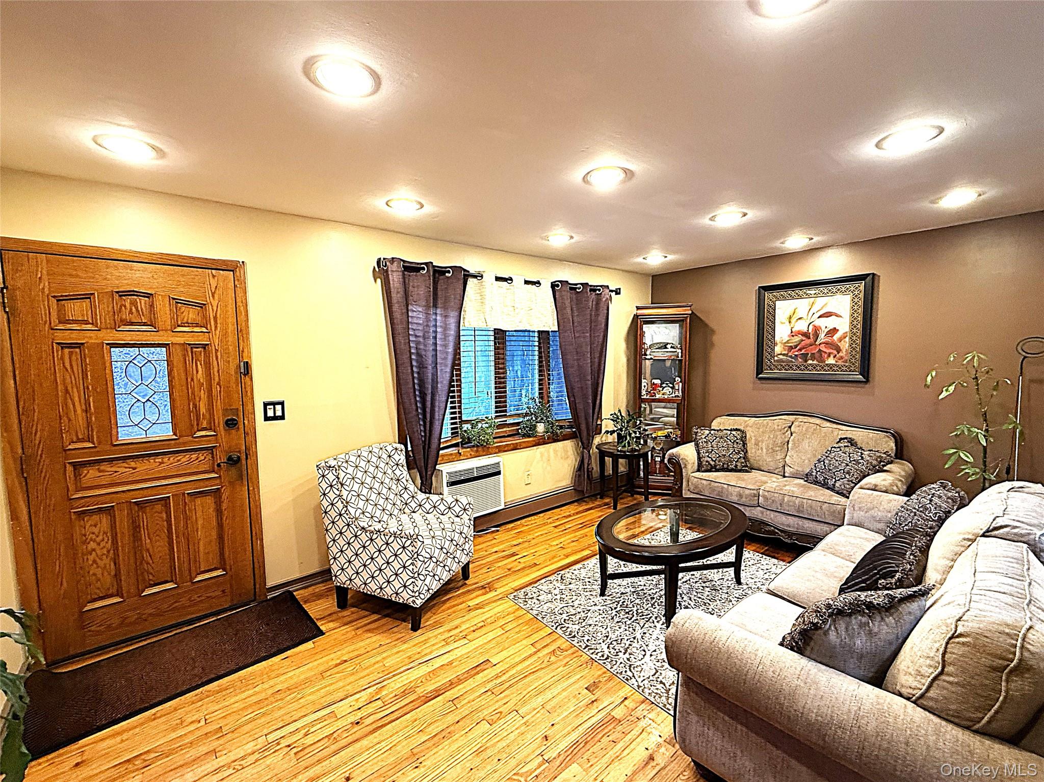 1 Heston Road Shirley, NY 11967 - Photo 9 of 32 Living area featuring wood-finish flooring, recessed lighting, and a paneled entry door with decorative glass