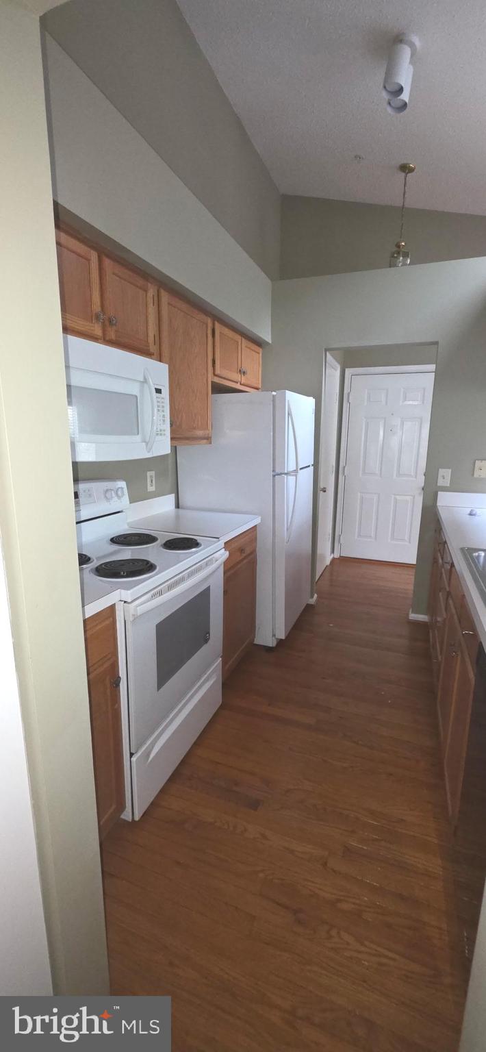 14201 Woolen Oak Court, Unit 932 Silver Spring, MD 20906 - Photo 5 of 10 a kitchen with stainless steel appliances a stove a sink and a refrigerator