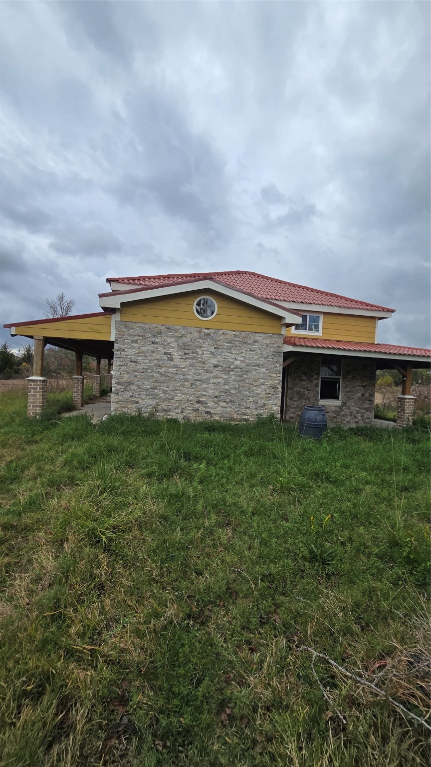 3535 Peveto Road Orange, TX 77632 - Photo 2 of 11 a view of a big house with a big yard and a large tree