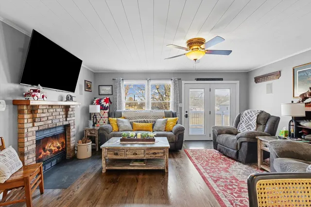a living room with furniture fireplace and a flat screen tv