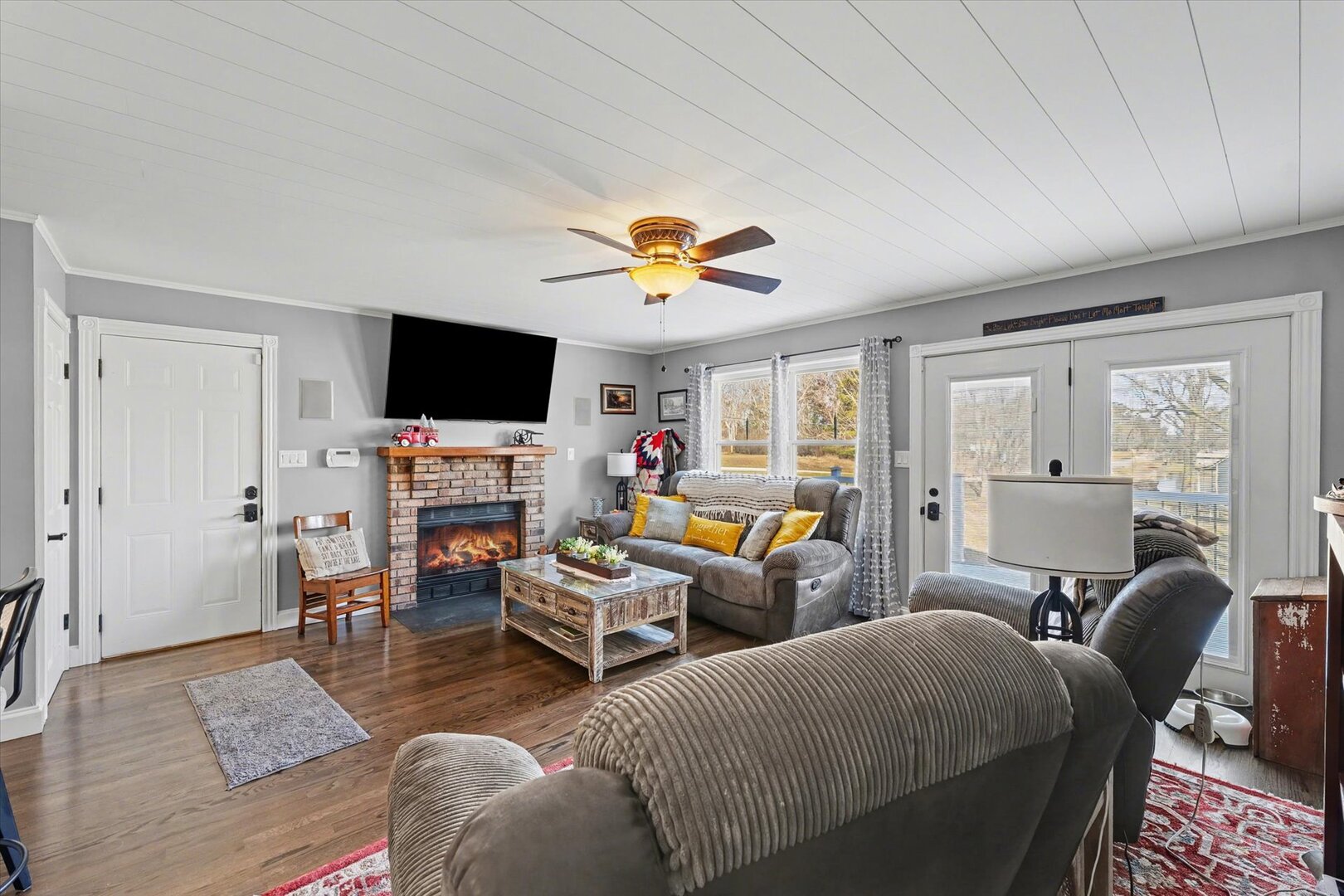 808 South Spring Lake Road Mahomet, IL 61853 - Photo 17 of 37 a living room with furniture a flat screen tv and a window