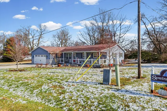 a backyard of a house with table and chairs