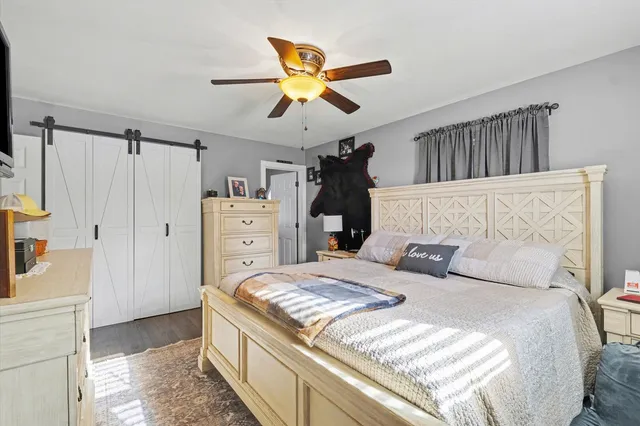 a bedroom with a large bed and a chandelier