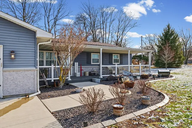a view of a house with backyard fire pit and couches