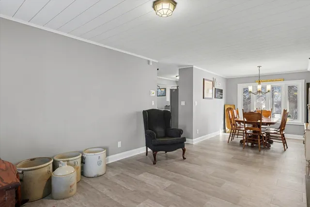 a view of a workspace with furniture and a potted plant