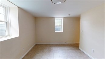 8 Brandley Road, Unit SF Watertown, MA 02472 - Photo 19 of 25 an empty room with windows