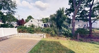 8 Brandley Road, Unit SF Watertown, MA 02472 - Photo 25 of 25 a view of a yard with plants and a bench
