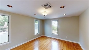 8 Brandley Road, Unit SF Watertown, MA 02472 - Photo 8 of 25 a view of empty room with window and wooden floor