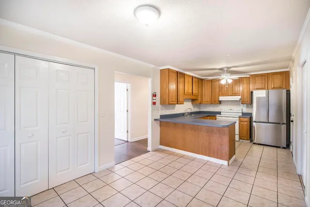 a kitchen with stainless steel appliances granite countertop a refrigerator and a sink