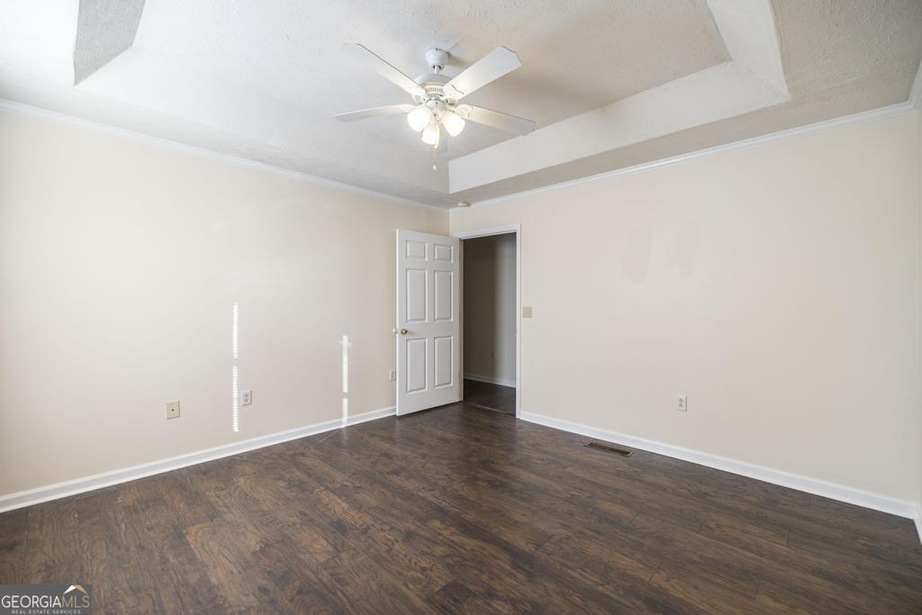 411 Cypress Drive Dublin, GA 31021 - Photo 18 of 31 a view of an empty room with wooden floor