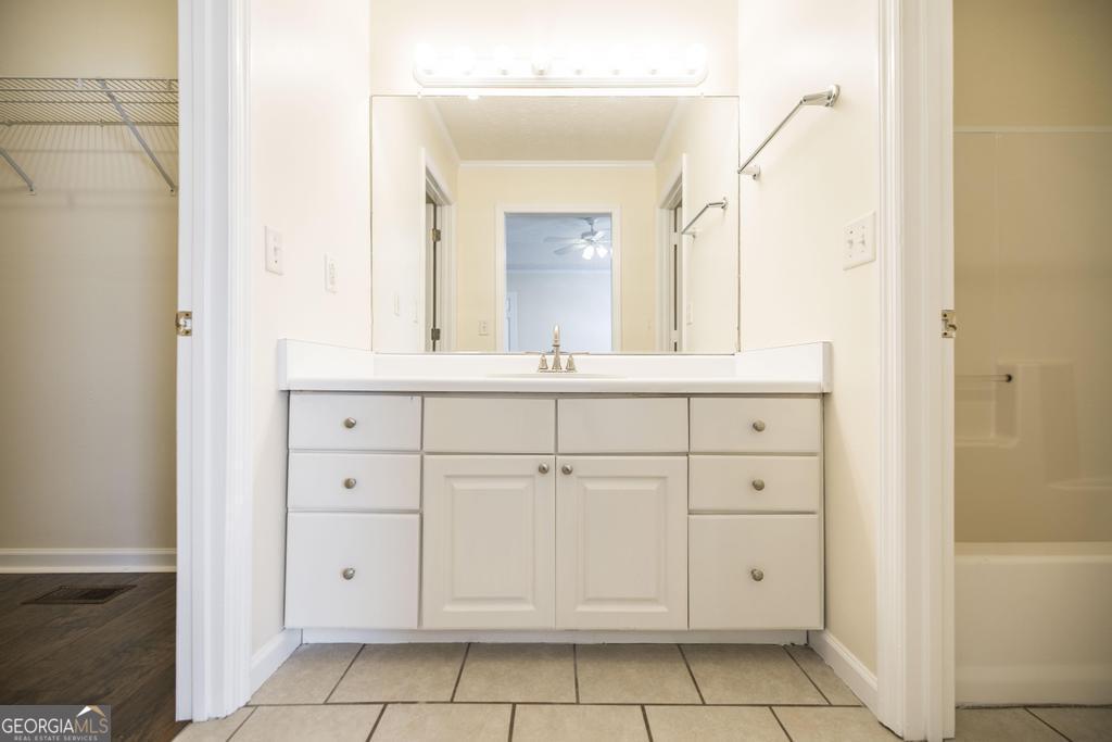 411 Cypress Drive Dublin, GA 31021 - Photo 19 of 31 a bathroom with a sink a vanity and a mirror
