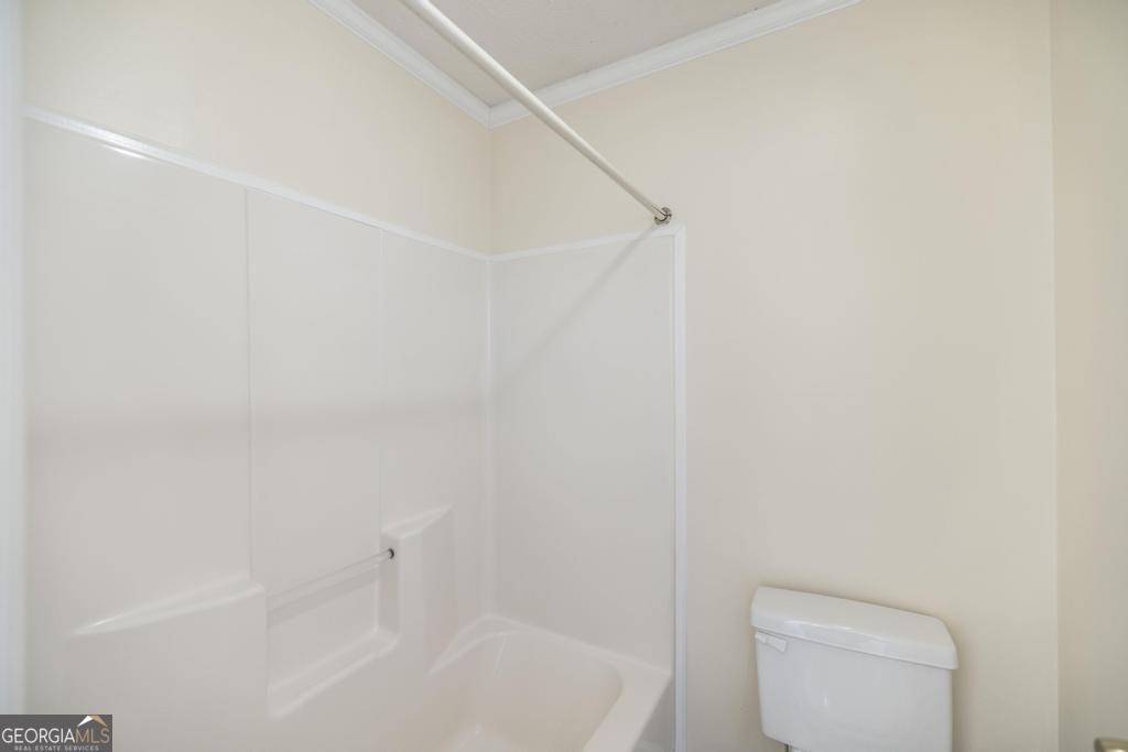 411 Cypress Drive Dublin, GA 31021 - Photo 20 of 31 a bathroom with a toilet and shower