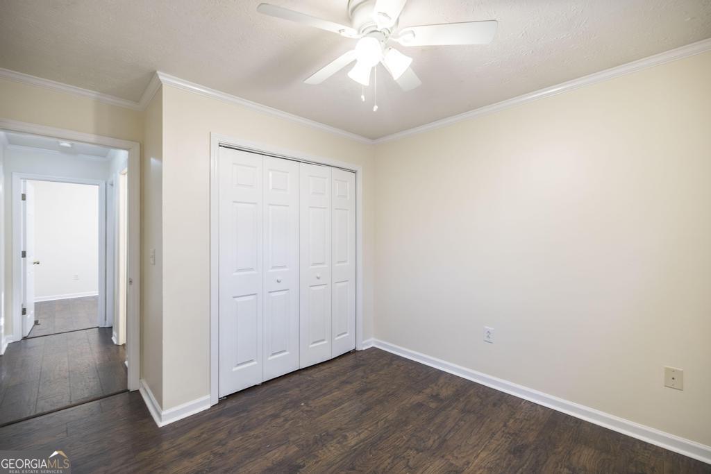 411 Cypress Drive Dublin, GA 31021 - Photo 23 of 31 an empty room with wooden floor and fan