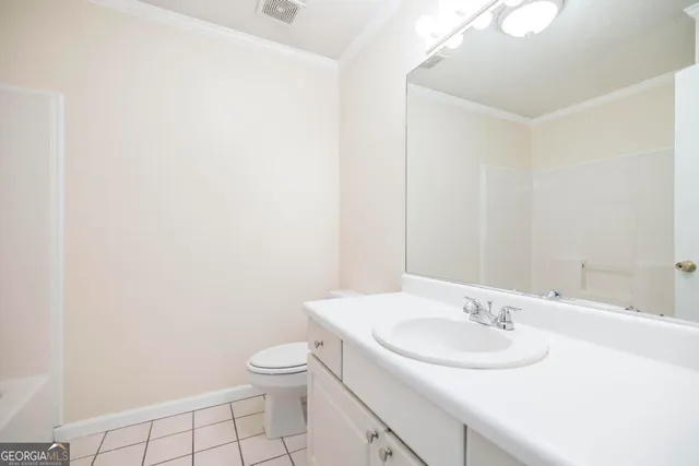 a bathroom with a sink toilet and a mirror