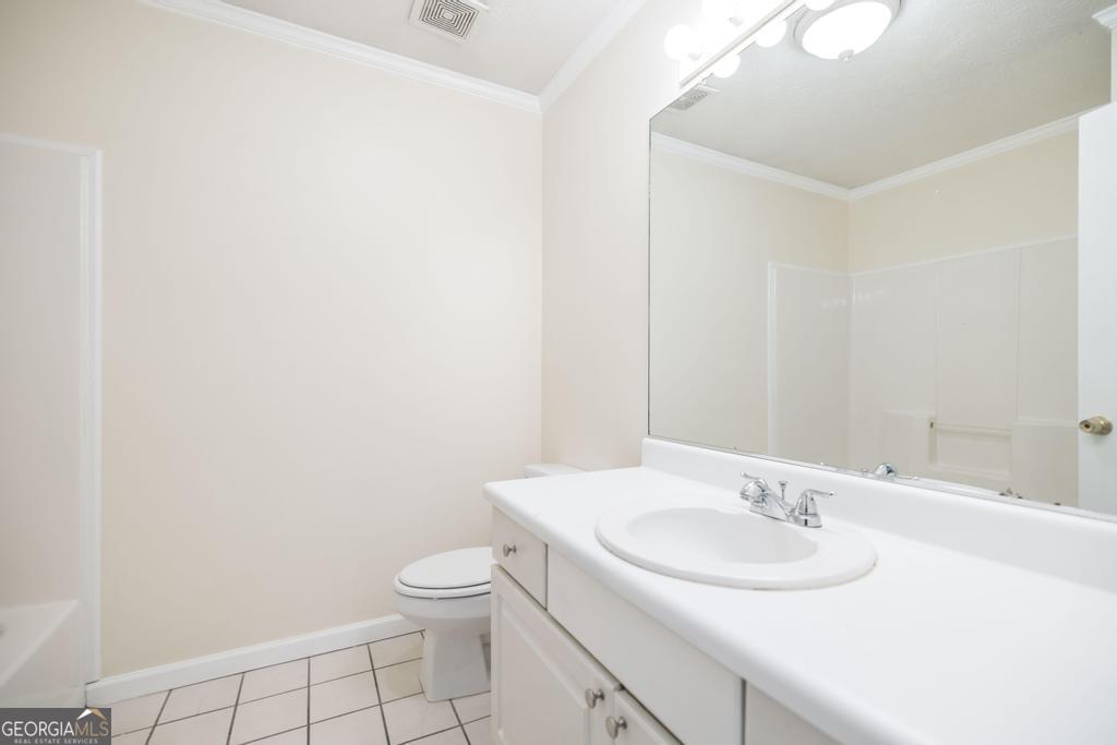 411 Cypress Drive Dublin, GA 31021 - Photo 24 of 31 a bathroom with a sink toilet and a mirror