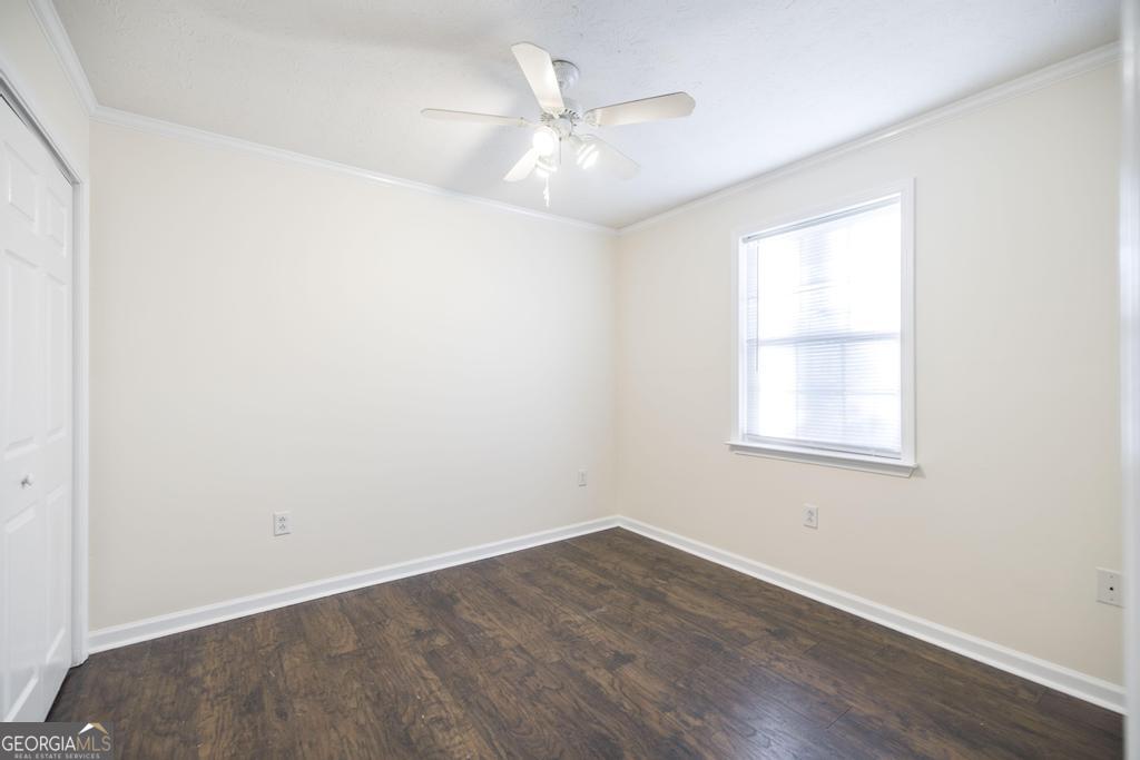 411 Cypress Drive Dublin, GA 31021 - Photo 25 of 31 an empty room with wooden floor and windows