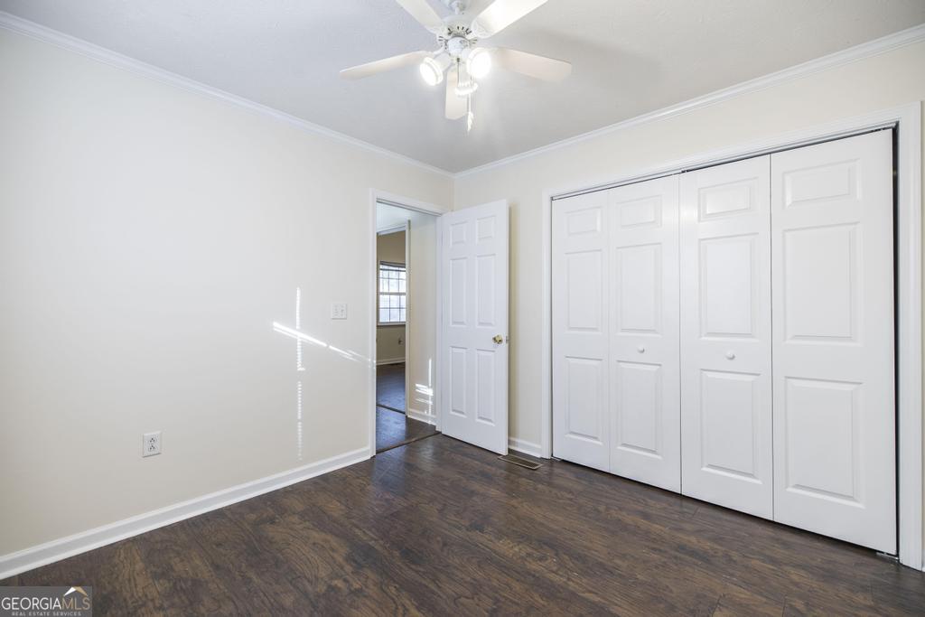 411 Cypress Drive Dublin, GA 31021 - Photo 26 of 31 an empty room with wooden floor closet and windows