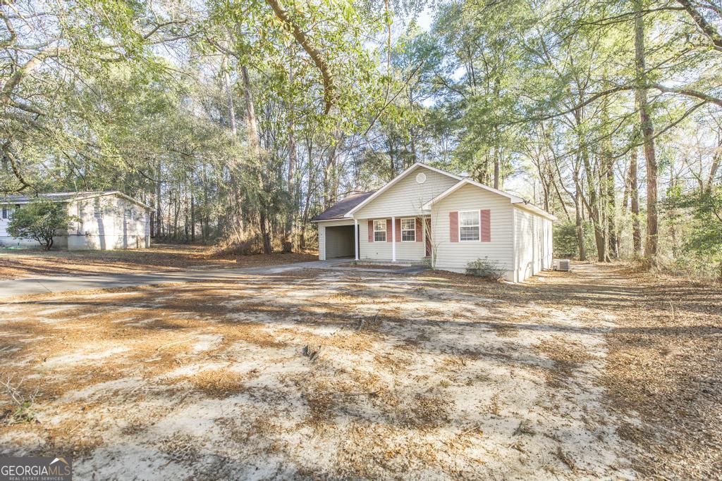 411 Cypress Drive Dublin, GA 31021 - Photo 3 of 31 a view of a house with a yard and large tree