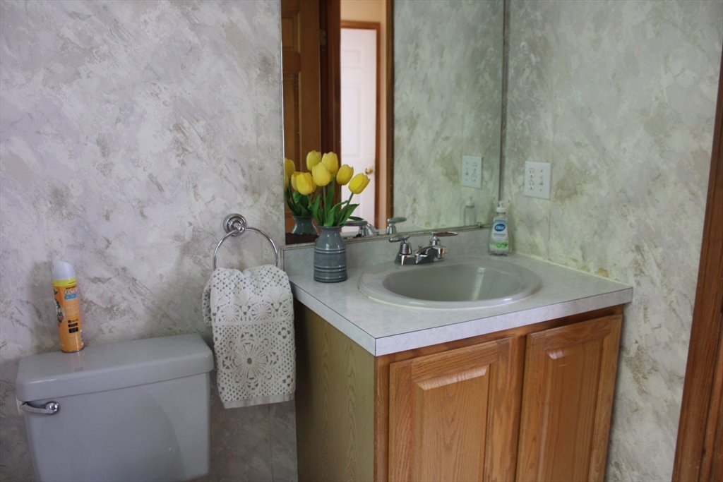 27 Gretchen Way Raynham, MA 02767 - Photo 10 of 20 a bathroom with a granite countertop sink and a mirror