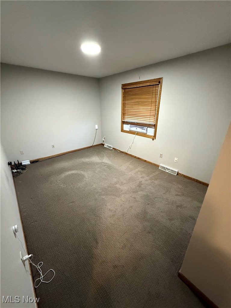5115 Raspberry Lane Mineral Ridge, OH 44440 - Photo 21 of 25 Empty room with visible vents, baseboards, and carpet