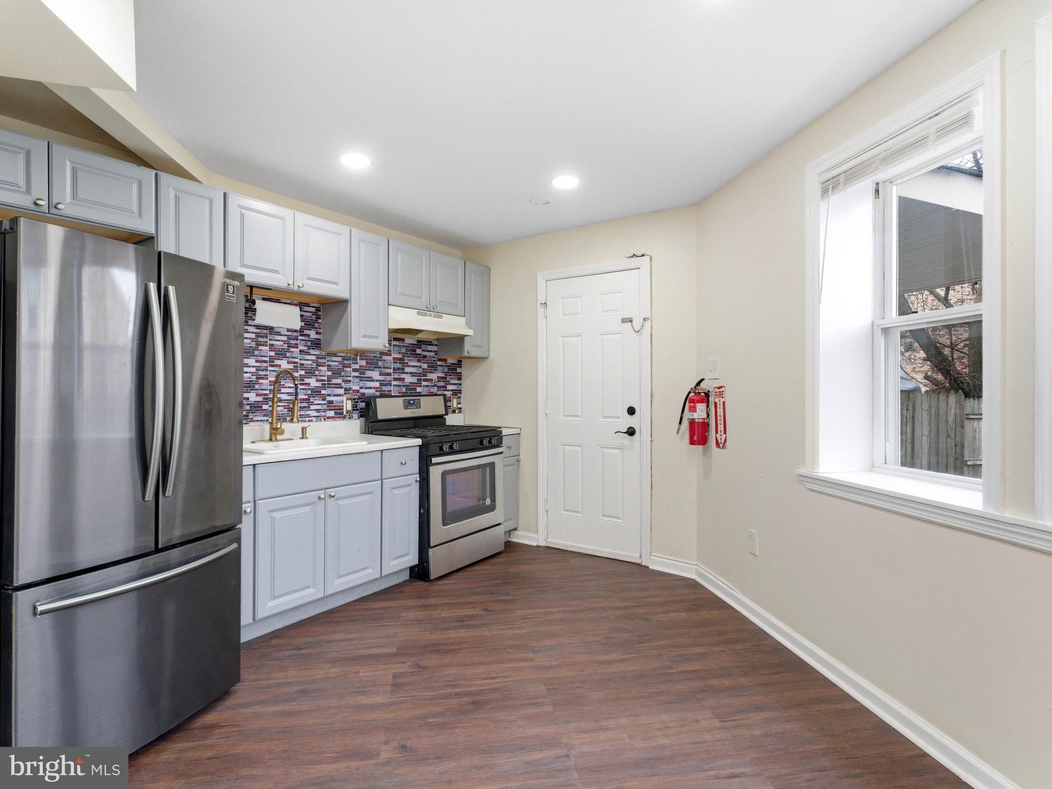 2976 North Congress Road Camden, NJ 08104 - Photo 11 of 25 a kitchen with granite countertop a refrigerator and a stove top oven