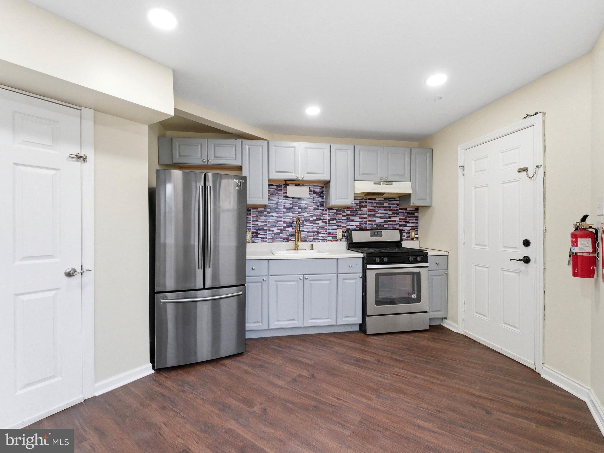 2976 North Congress Road Camden, NJ 08104 - Photo 12 of 25 a kitchen with a refrigerator and a stove top oven