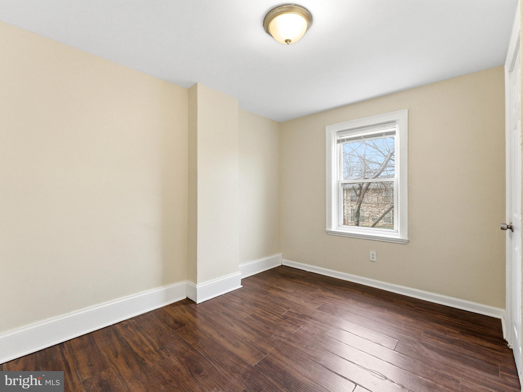 2976 North Congress Road Camden, NJ 08104 - Photo 17 of 25 an empty room with wooden floor and windows