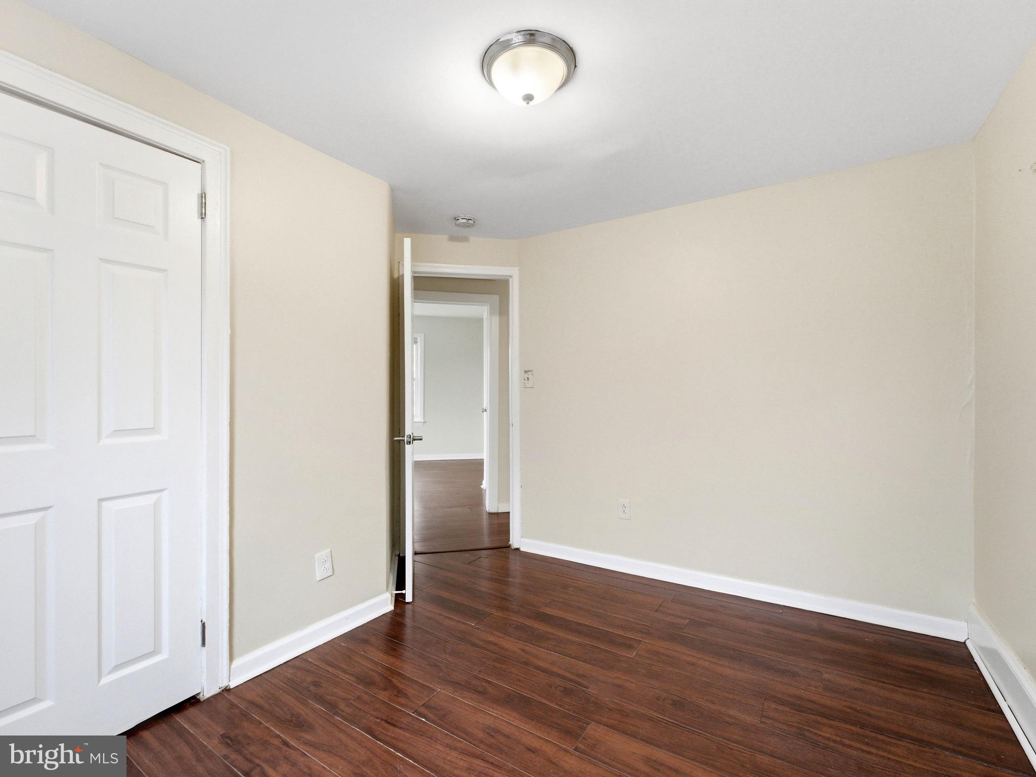 2976 North Congress Road Camden, NJ 08104 - Photo 21 of 25 an empty room with wooden floor and windows