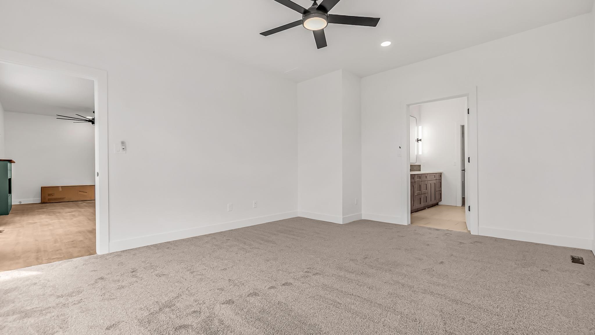 214 Limberpine Circle Parachute, CO 81635 - Photo 10 of 24 an empty room with a ceiling fan and kitchen view