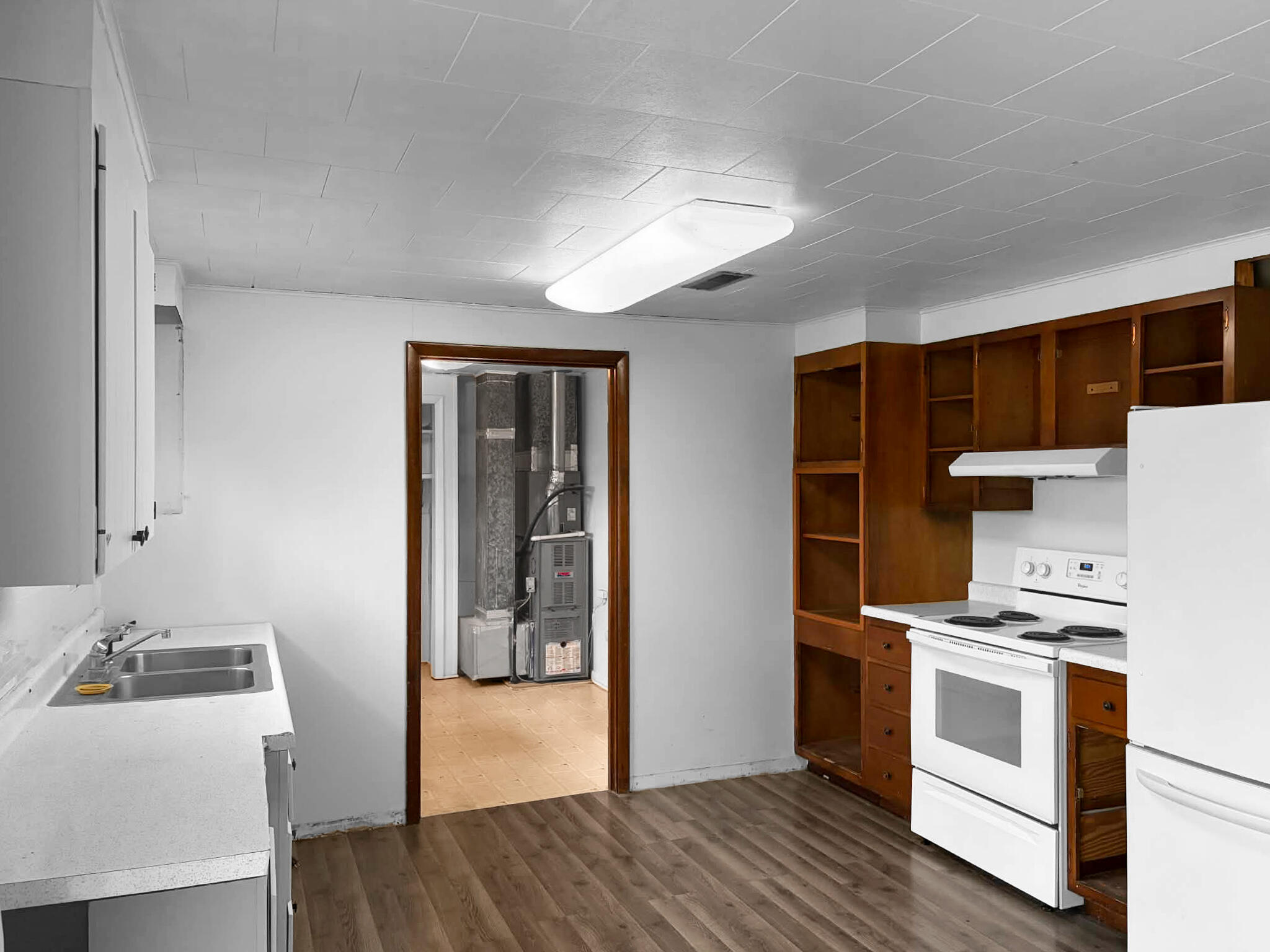 710 West Charles Street Rensselaer, IN 47978 - Photo 7 of 16 a kitchen with a stove cabinets and wooden floor