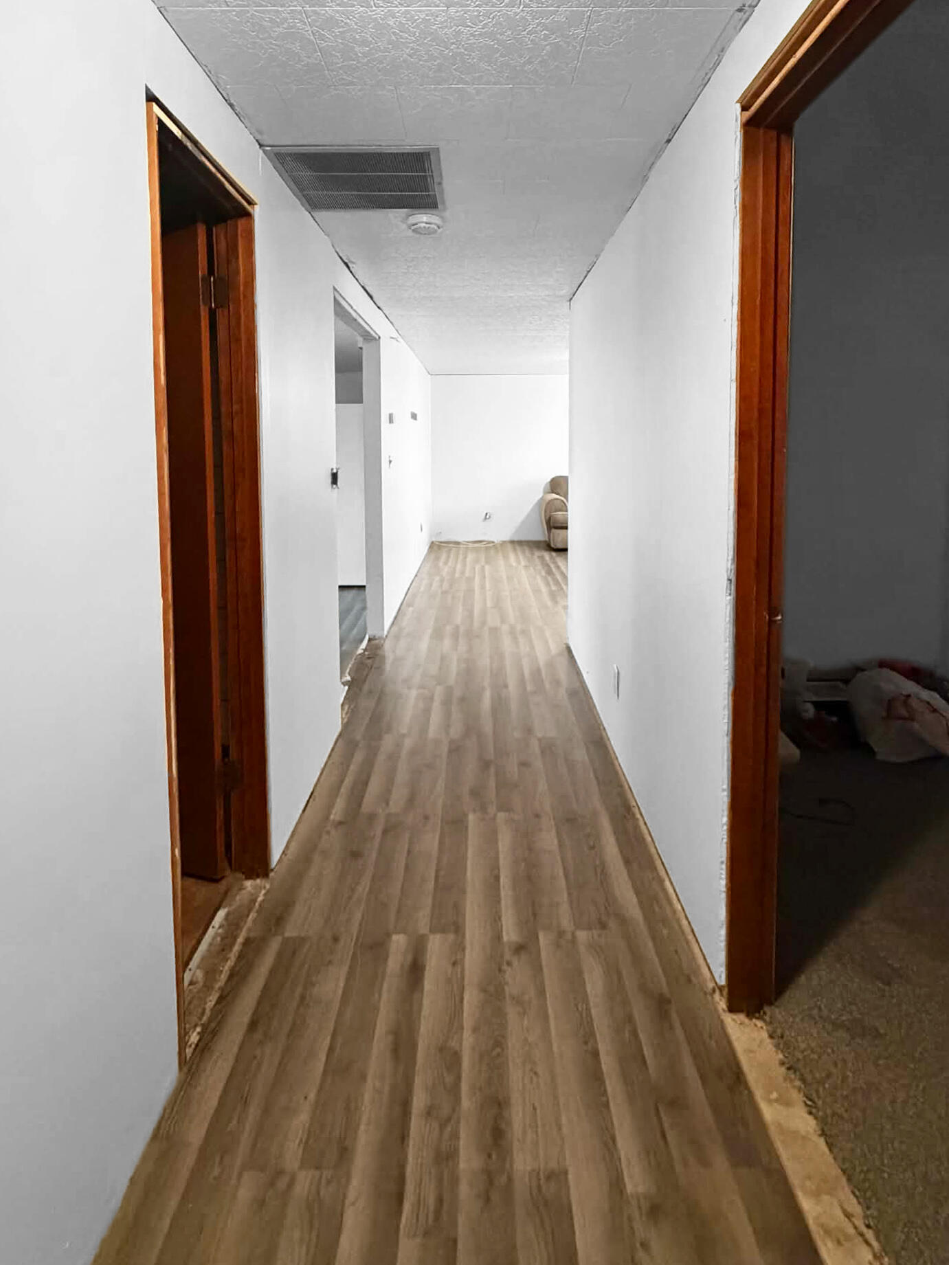 710 West Charles Street Rensselaer, IN 47978 - Photo 8 of 16 a view of a hallway with wooden floor and a bathroom