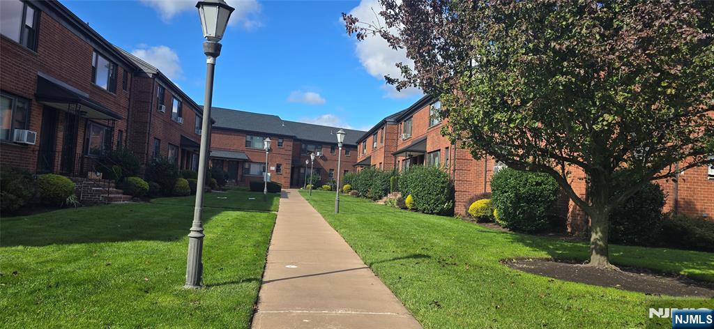 a front view of a house with a yard and pathway