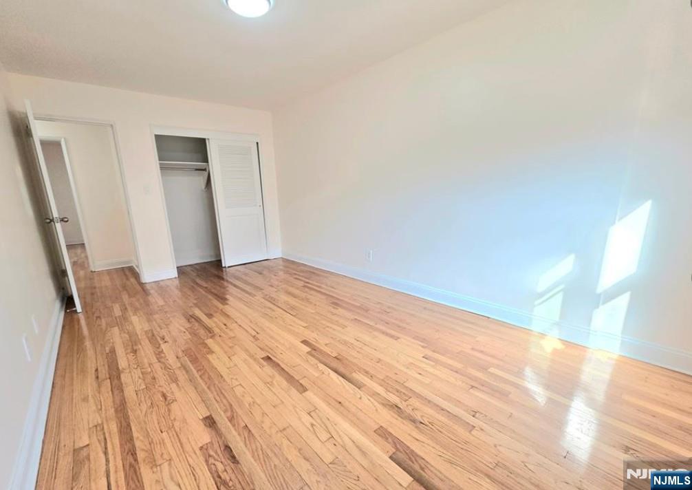 2173 North Central Road, Unit C Fort Lee, NJ 07024 - Photo 4 of 11 a view of empty room with wooden floor