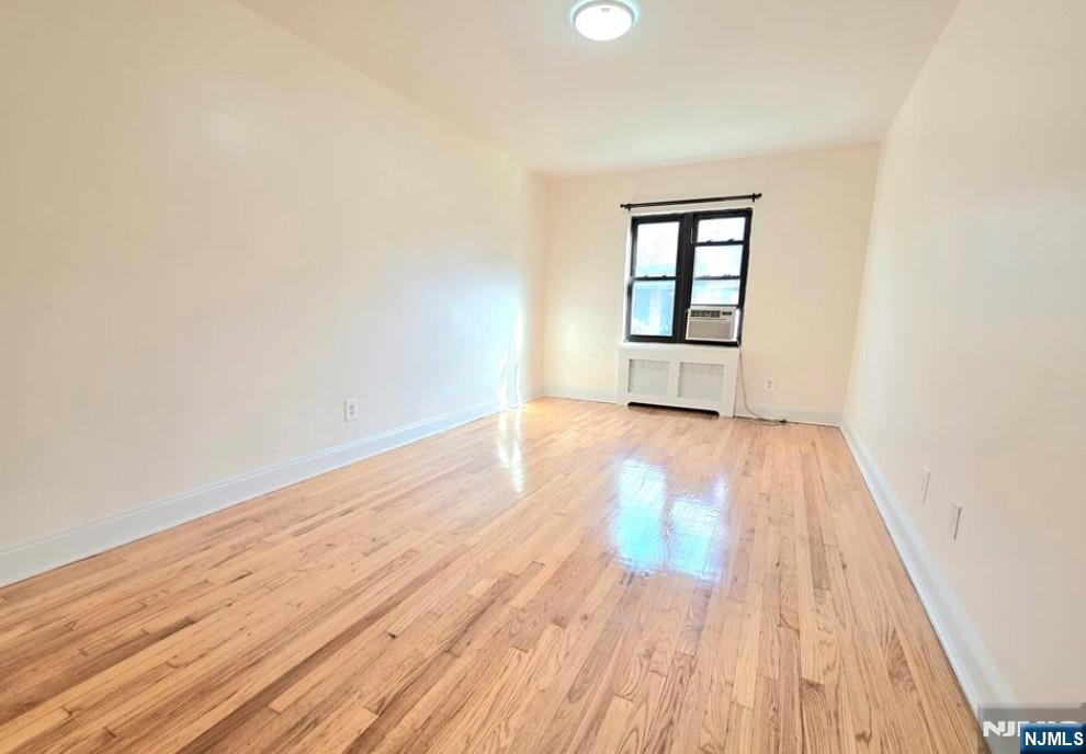 2173 North Central Road, Unit C Fort Lee, NJ 07024 - Photo 5 of 11 an empty room with wooden floor and windows