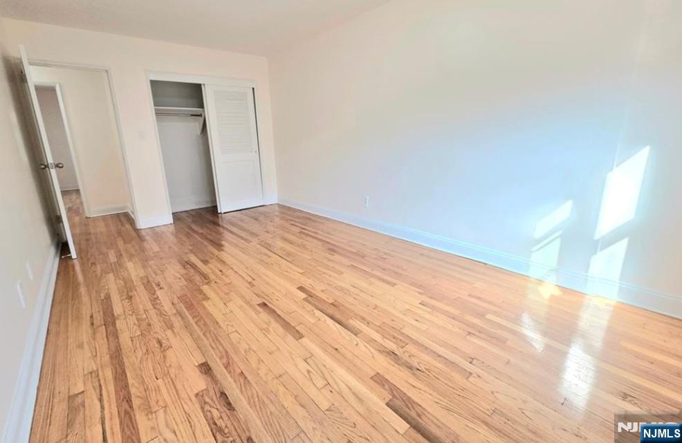 2173 North Central Road, Unit C Fort Lee, NJ 07024 - Photo 6 of 11 a view of empty room with wooden floor