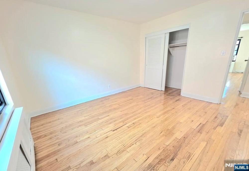 2173 North Central Road, Unit C Fort Lee, NJ 07024 - Photo 8 of 11 a view of empty room with wooden floor