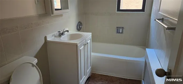 a bathroom with a sink a toilet and bathtub