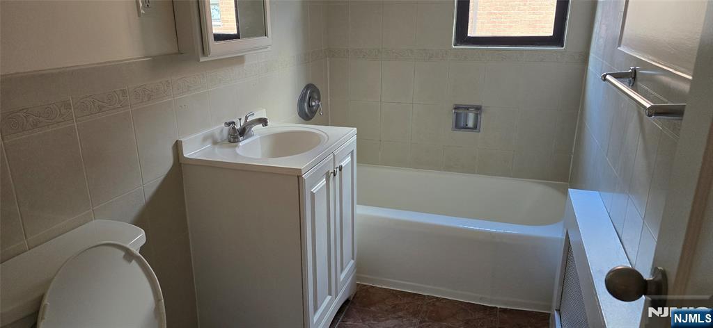 2173 North Central Road, Unit C Fort Lee, NJ 07024 - Photo 9 of 11 a bathroom with a sink a toilet and shower