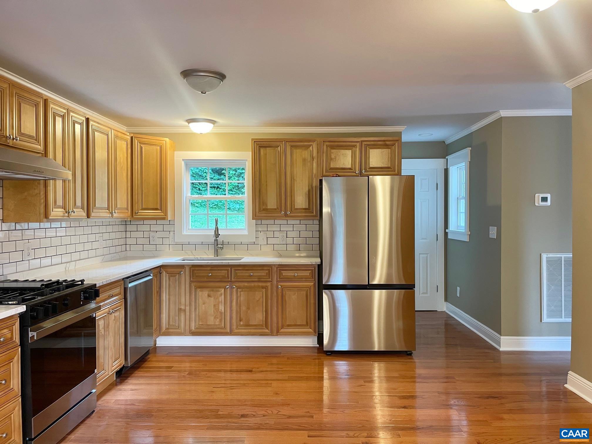 5420 Cove Garden Road Covesville, VA 22931 - Photo 7 of 27 a kitchen with granite countertop stainless steel appliances a refrigerator and wooden cabinets