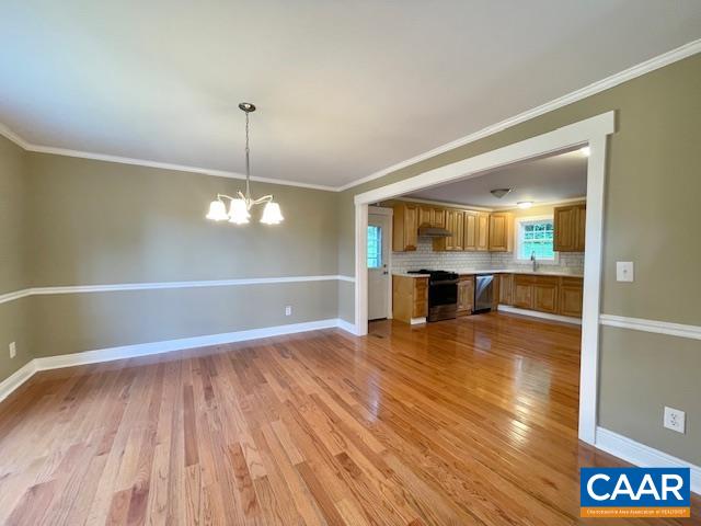 5420 Cove Garden Road Covesville, VA 22931 - Photo 10 of 27 a view of a room with wooden floor and kitchen view