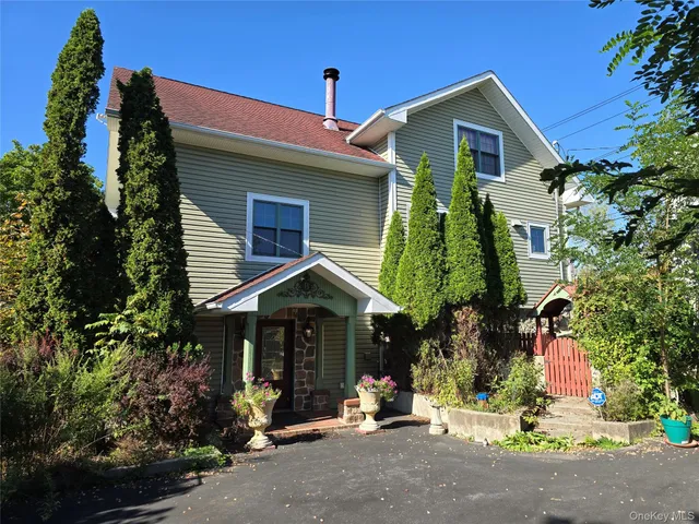 a front view of a house with a road