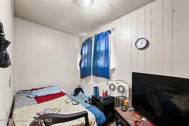 a bedroom with a bed and a fireplace