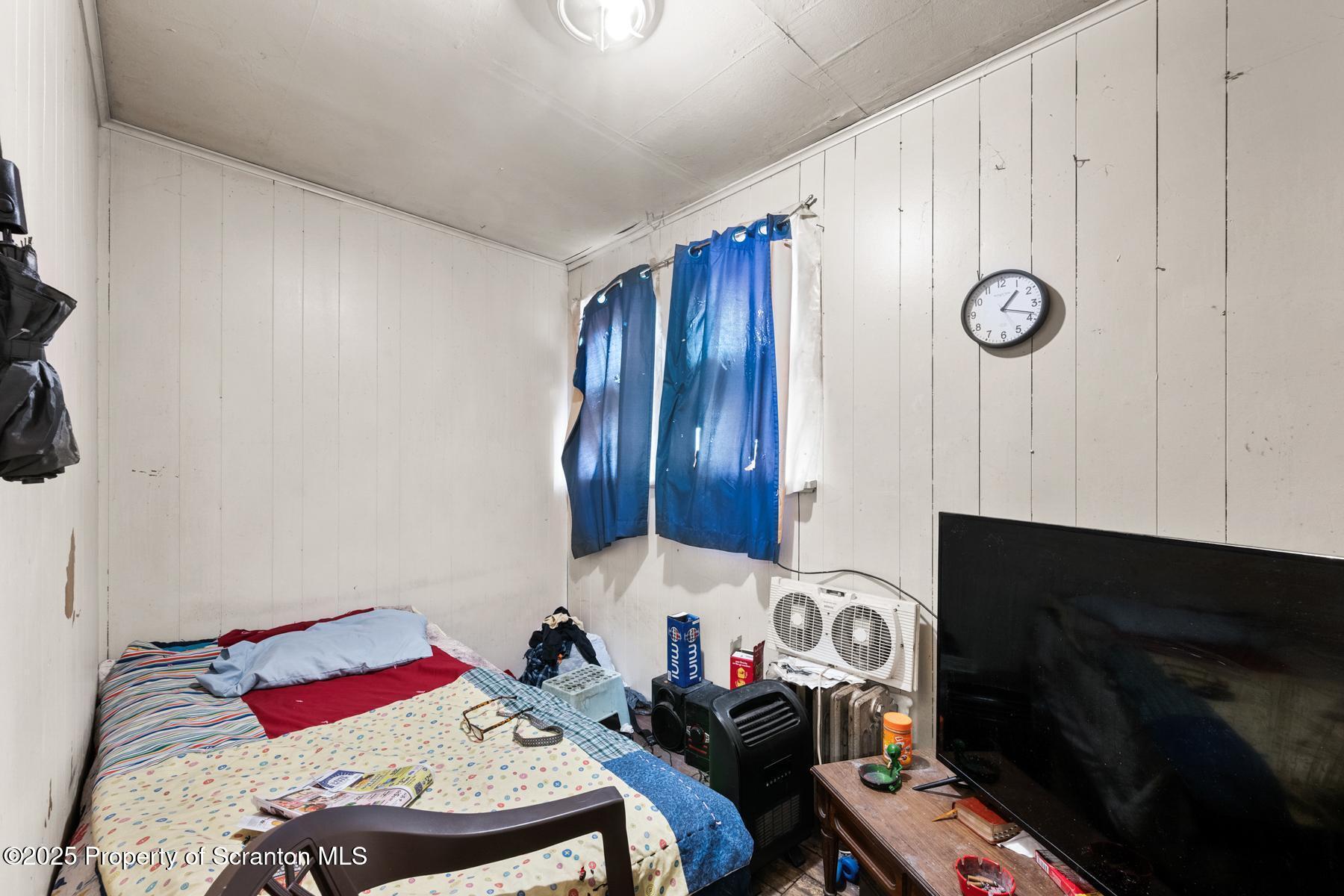 1019 South Webster Avenue Scranton, PA 18505 - Photo 11 of 36 a bedroom with a bed and a fireplace