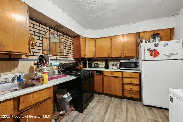 a kitchen with stainless steel appliances a sink and cabinets