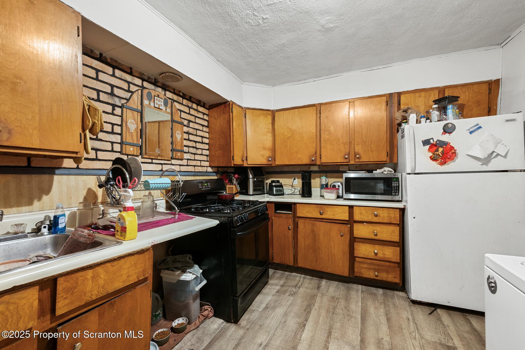 1019 South Webster Avenue Scranton, PA 18505 - Photo 13 of 36 a kitchen with stainless steel appliances a sink and cabinets