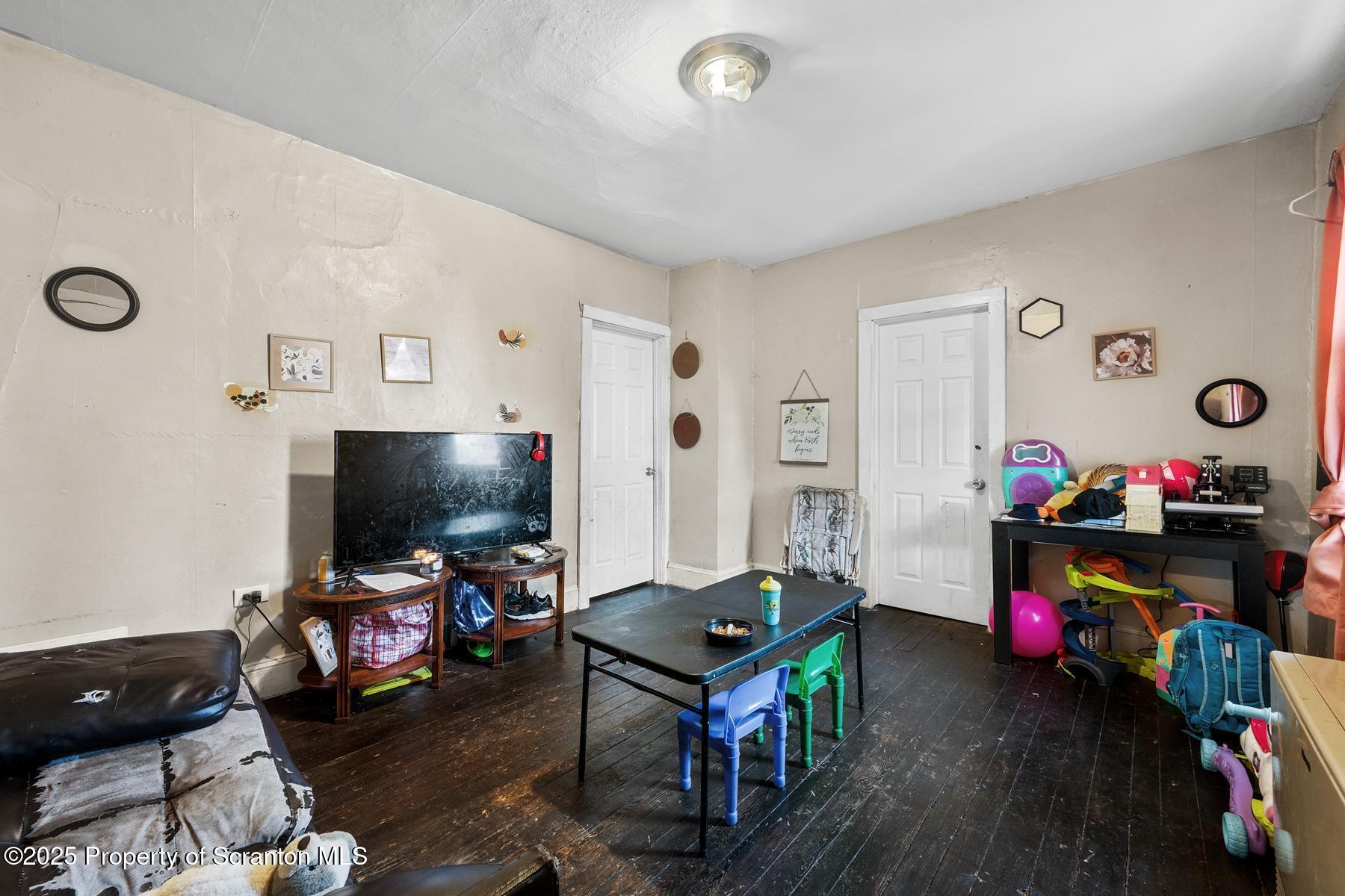 1019 South Webster Avenue Scranton, PA 18505 - Photo 26 of 36 a living room with furniture and a flat screen tv