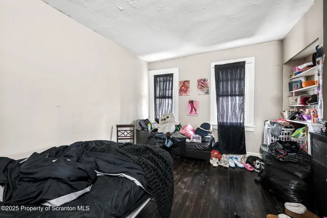 a bedroom with bed and a window