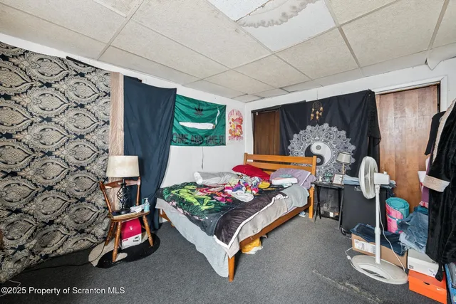 a bedroom with furniture and a flat screen tv